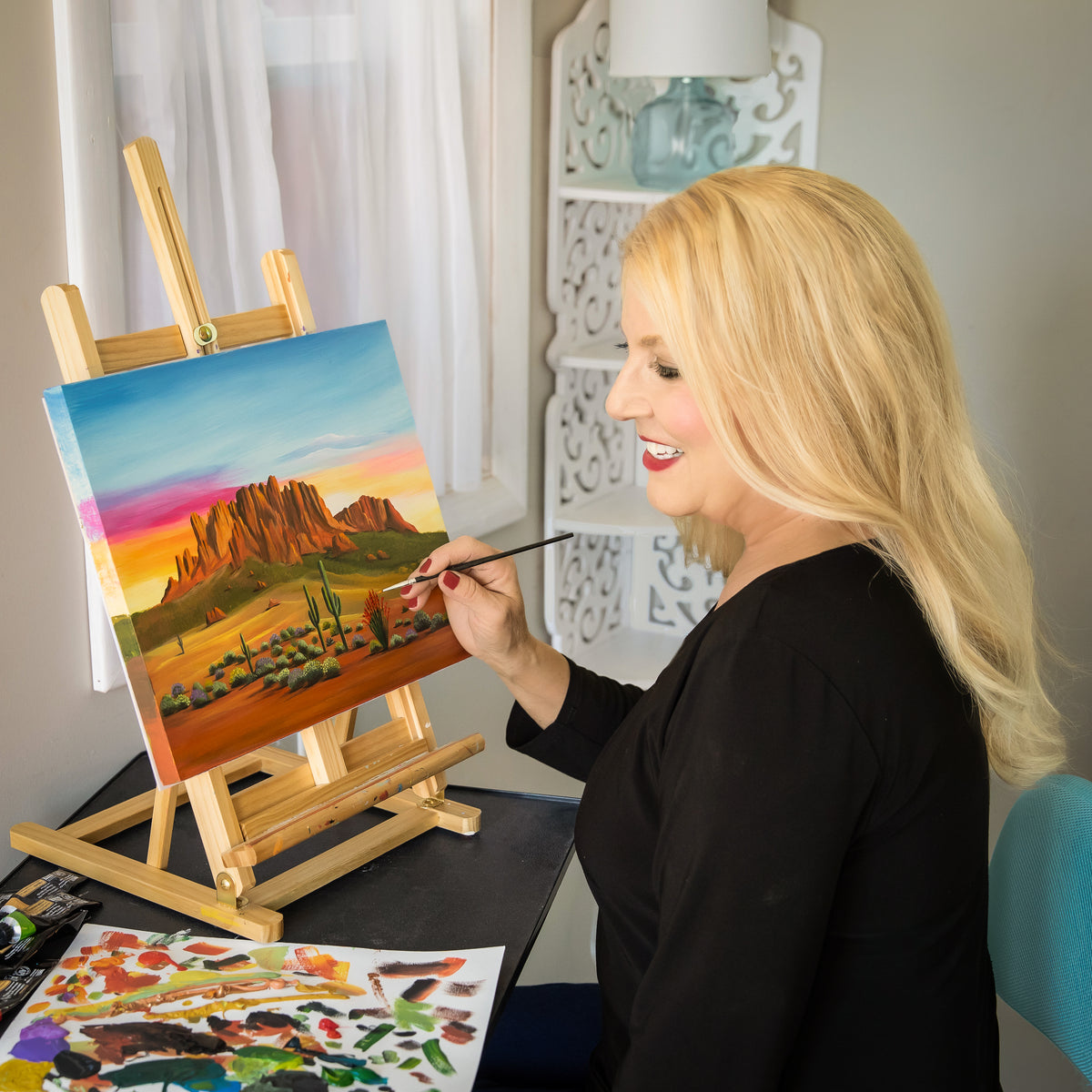 Brenda in her studio painting the original Arizona Sunrise canvas