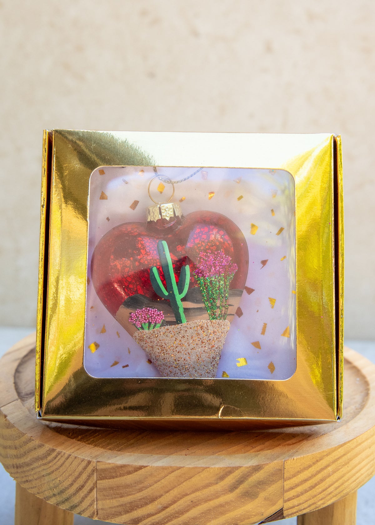 Limited Edition Desert Heart Hand Painted ornament on red sparkle glass by Brenda