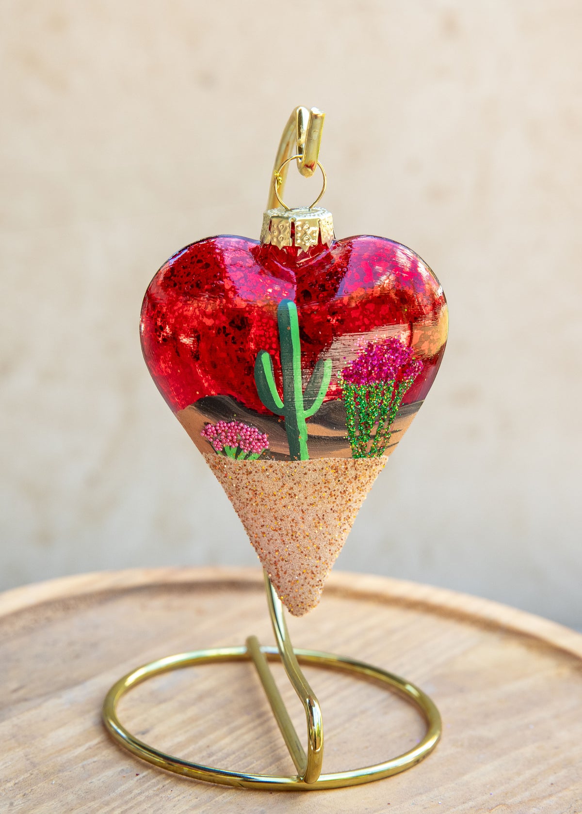 Limited Edition Desert Heart Hand Painted ornament on red sparkle glass by Brenda