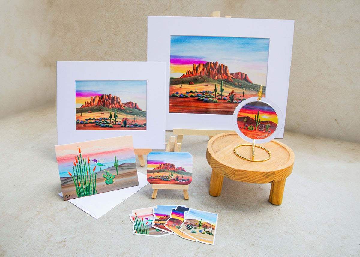 Sampler of Brenda's printed gifts: two art prints, a folded notecard, a magnet, an acrylic art ornament, and four Arizona-shaped stickers