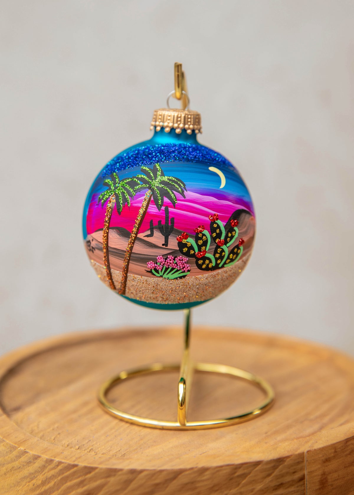 Moonlight Palms Hand Painted glass ornament by Brenda, palm trees and cactus under a crescent moon and pink sky