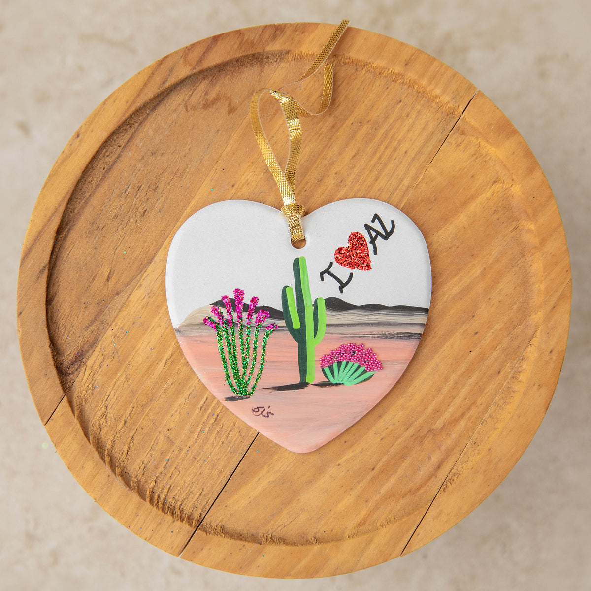 Limited Edition flat ceramic heart ornament with a desert scene and I Love AZ, hand painted by Brenda