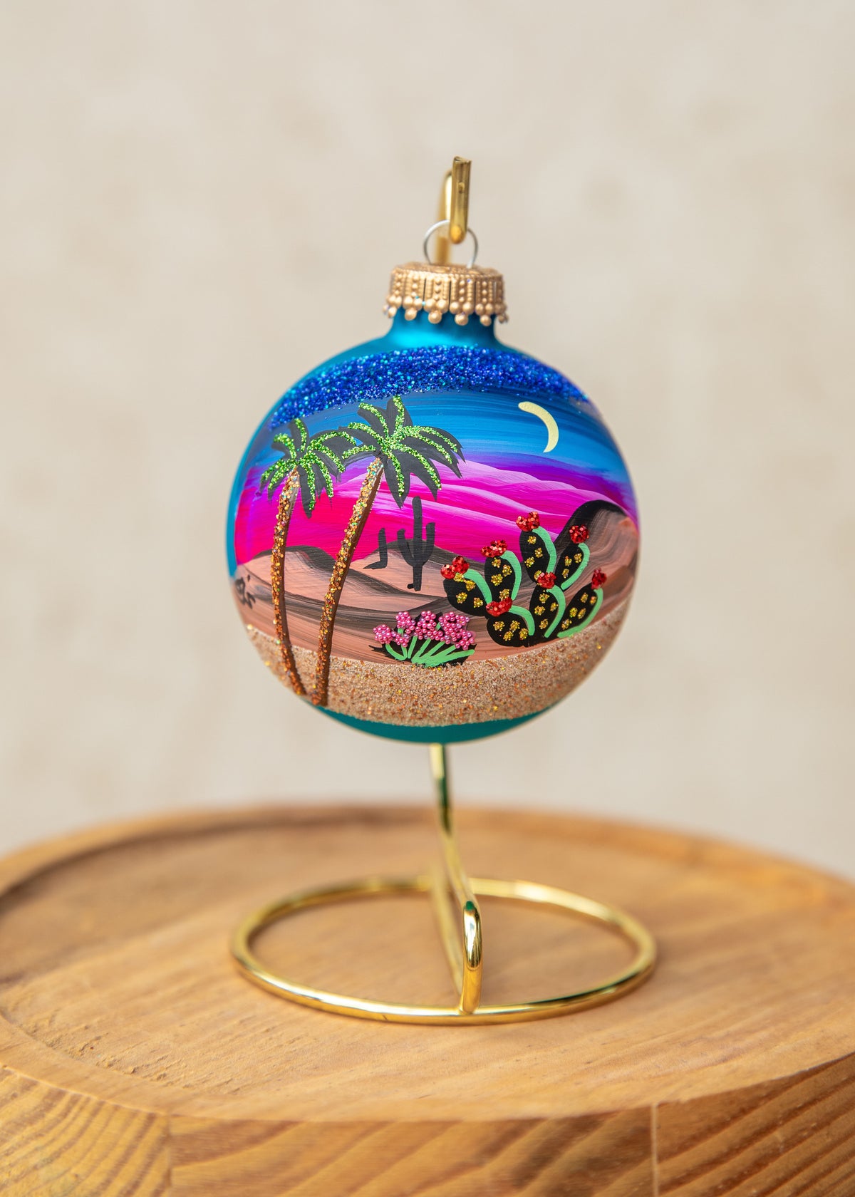 Moonlight Palms Hand Painted glass ornament by Brenda, palm trees and cactus under a crescent moon and pink sky