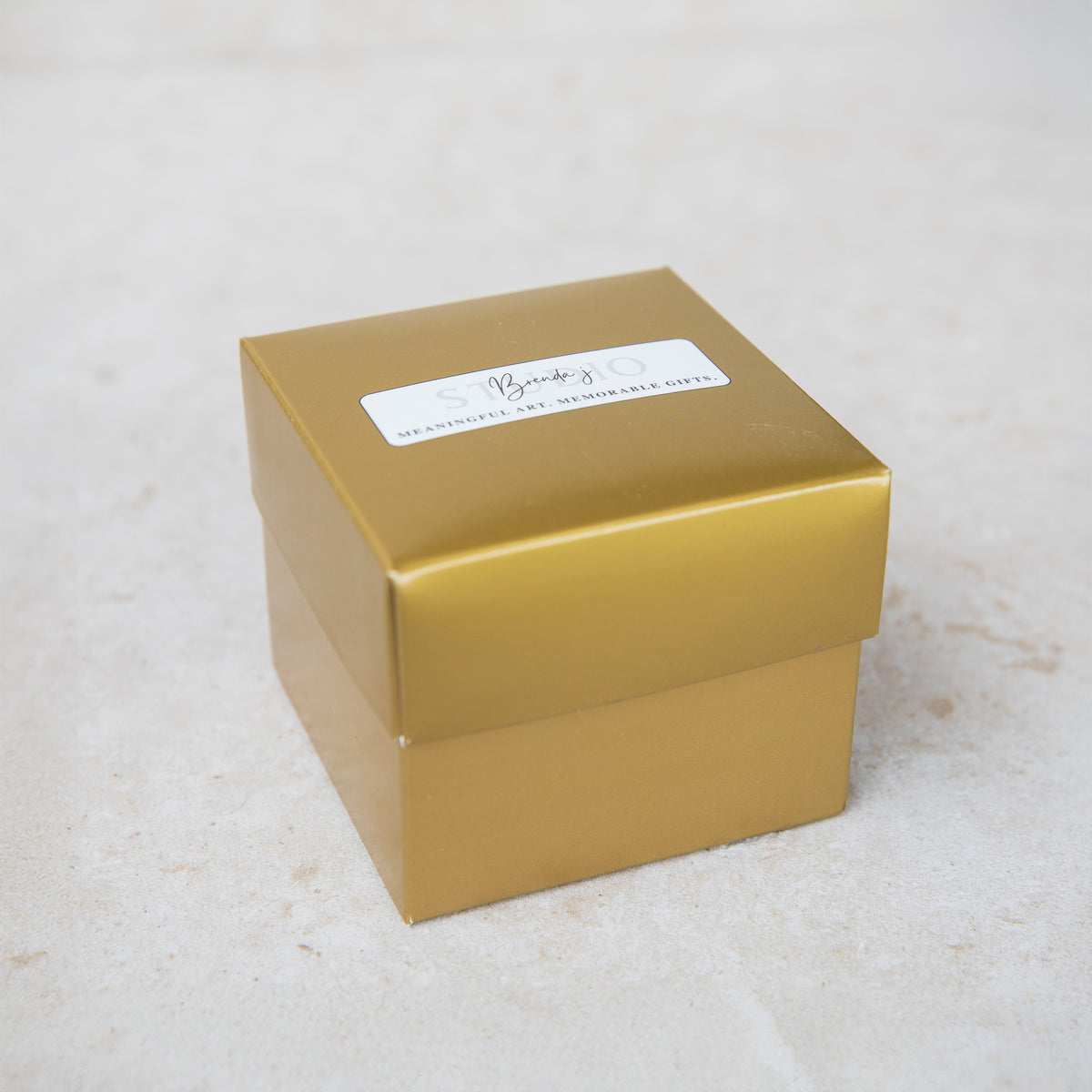 Closed two-piece gold gift box that every Hand Painted ornament arrives in