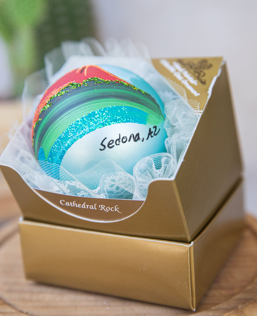 Sedona Hand Painted ornament turned on its side to show the Sedona, AZ name included on every Sedona design