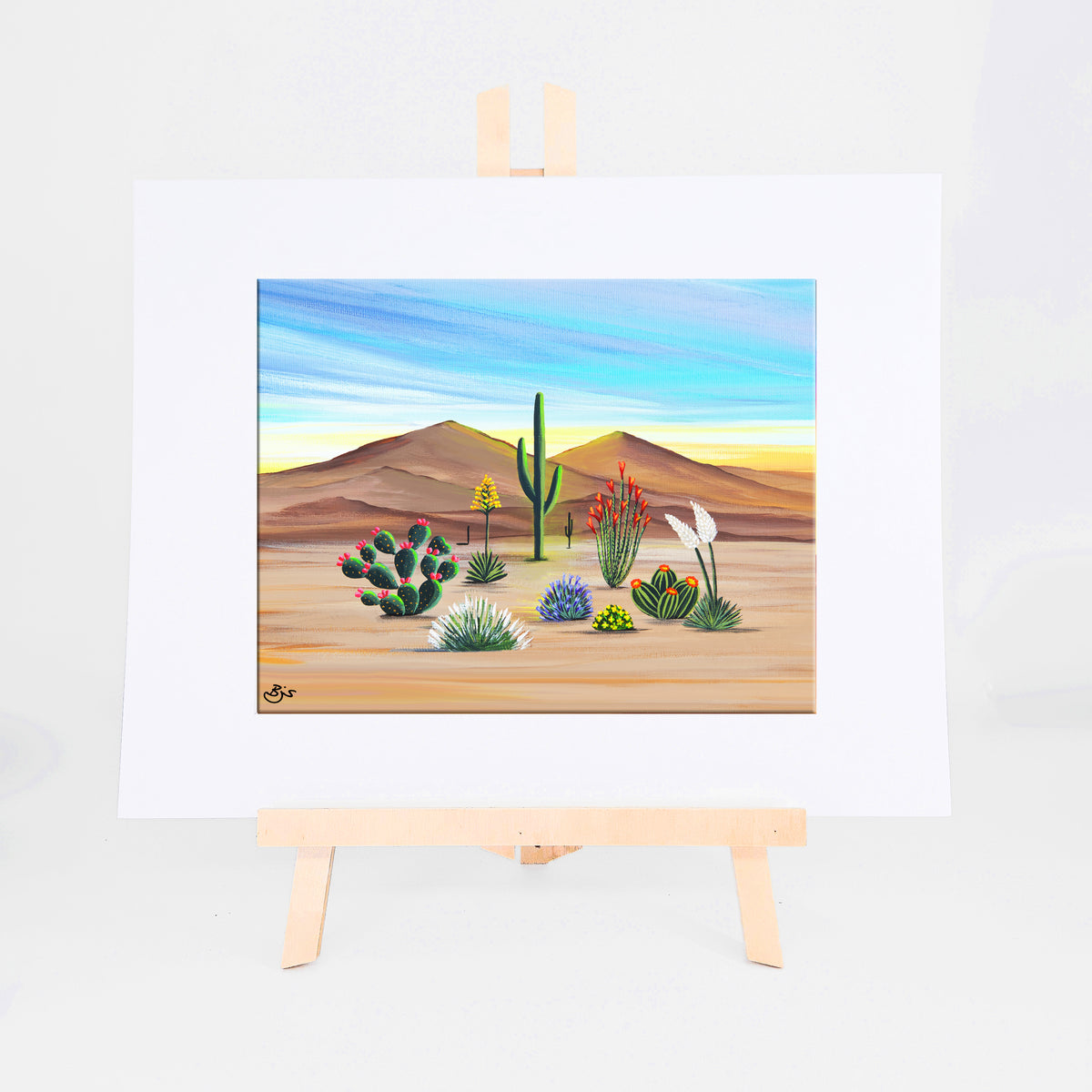 Desert in Bloom, Brenda's painting of saguaros, flowering prickly pear, ocotillo, agave, and wildflowers in warm sunlight, shown as a matted 8x10 art print