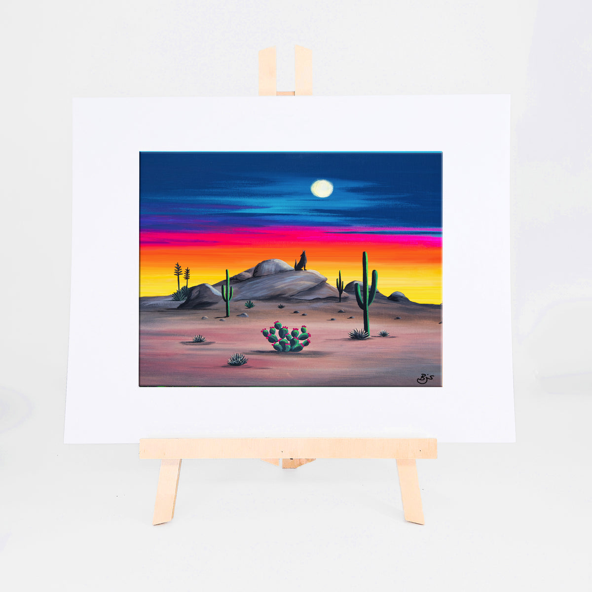 Howlin' Coyote, Brenda's painting of a coyote howling from a rocky ridge under a full moon and sunset sky, shown as a matted 8x10 art print